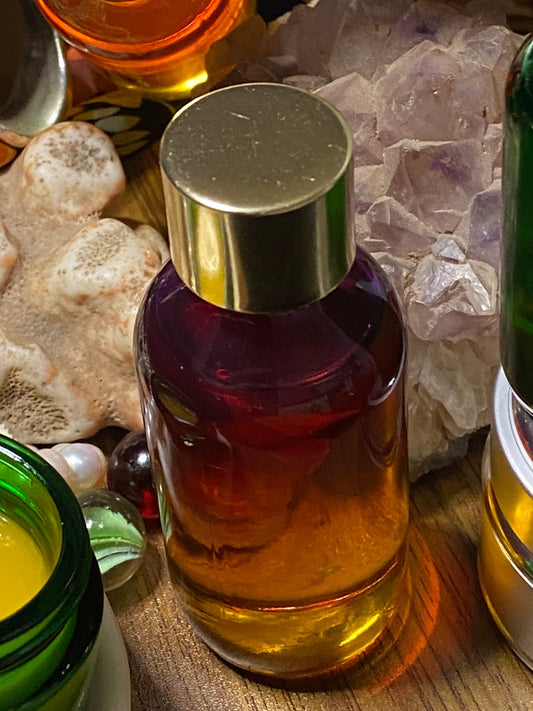 Celestial Pure Glow Oil Serum amber glass bottle styled with coral and amethyst crystals
