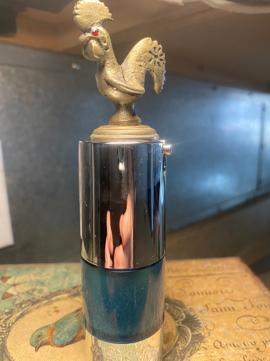 Blue Galactic Sea Flower high-peptide serum in chrome airless pump bottle with gold rooster topper